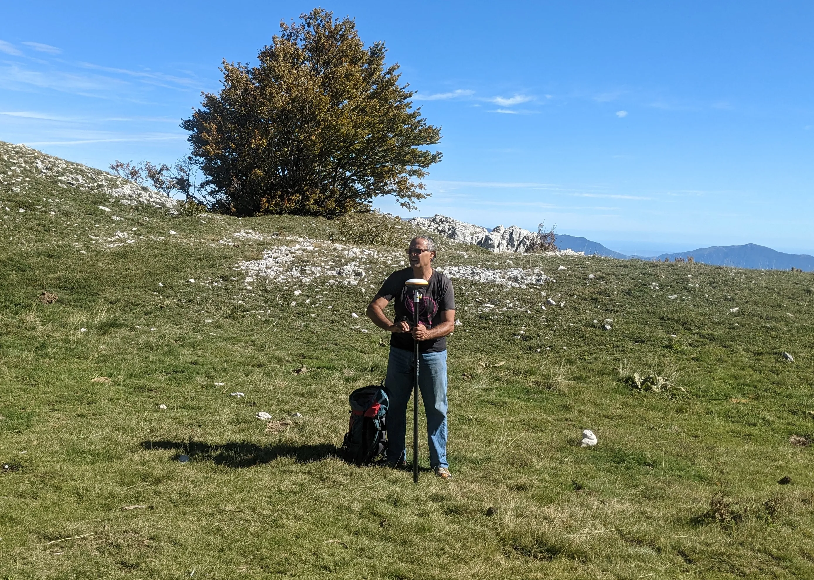 Foto di un geometra a lavoro con un teodolite.